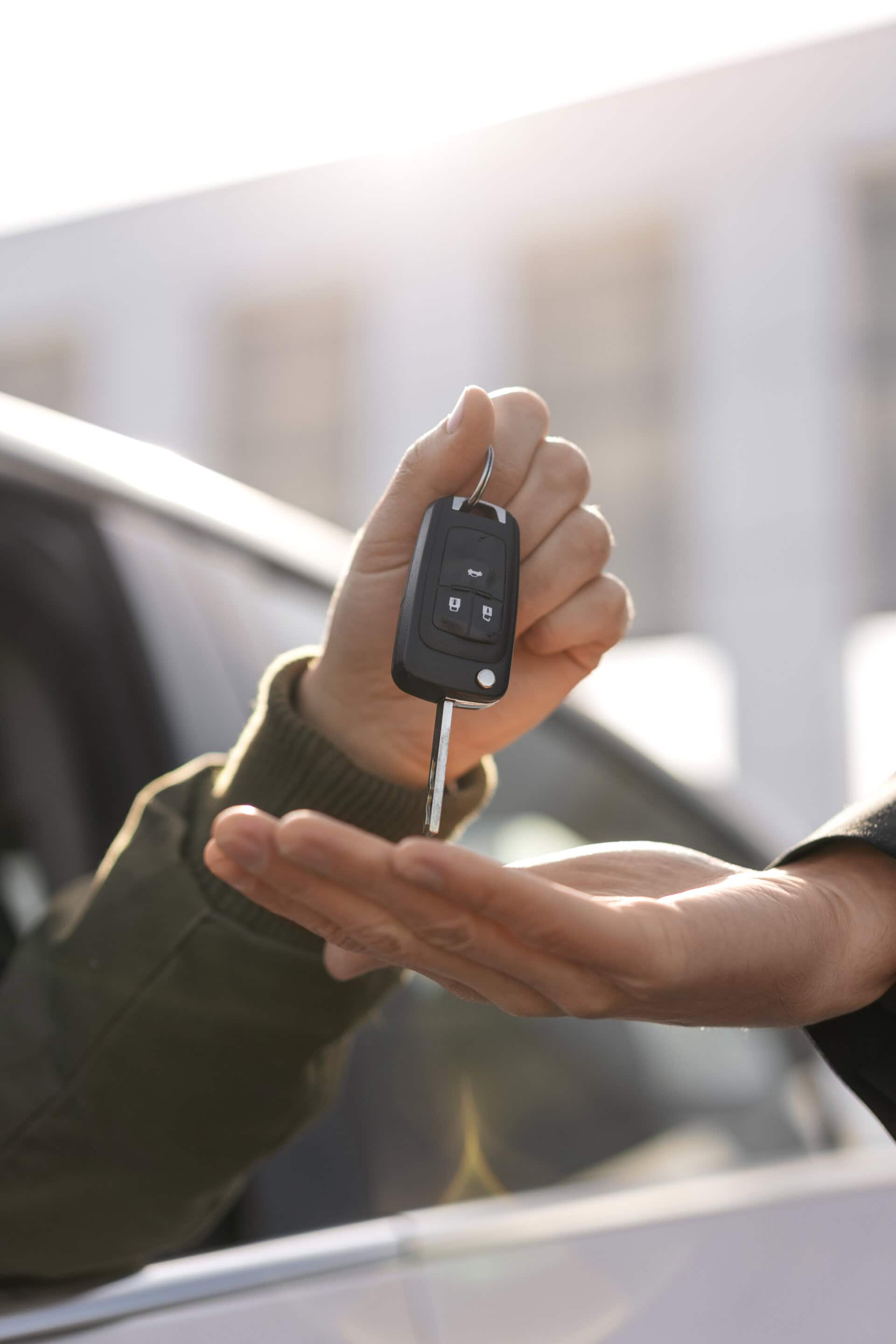 side-view-hands-holding-car-key